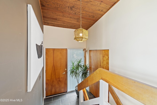 interior space featuring tile patterned floors, lofted ceiling, and wood ceiling