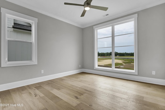 spare room featuring ceiling fan, light wood-type flooring, and crown molding