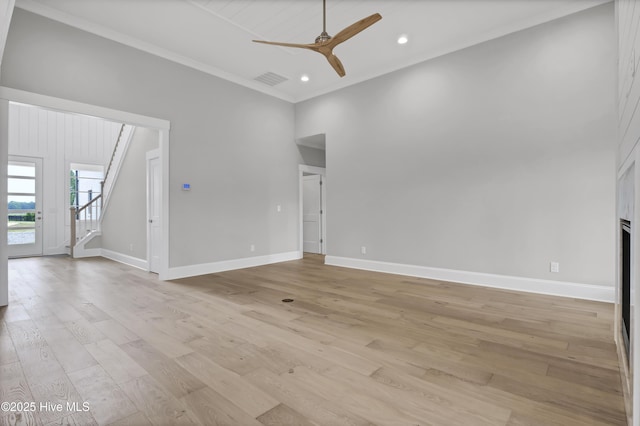 unfurnished living room featuring ceiling fan, light wood-type flooring, and ornamental molding