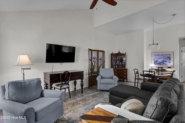 living room featuring ceiling fan with notable chandelier