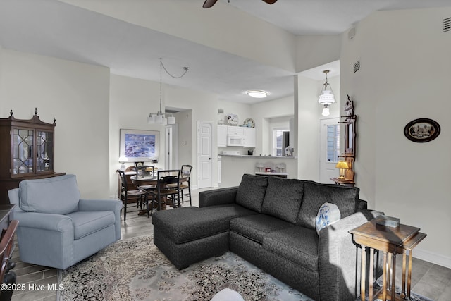 living room featuring hardwood / wood-style floors and ceiling fan