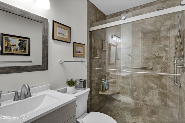 bathroom with vanity, an enclosed shower, and toilet