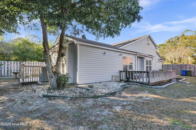 rear view of property featuring a deck