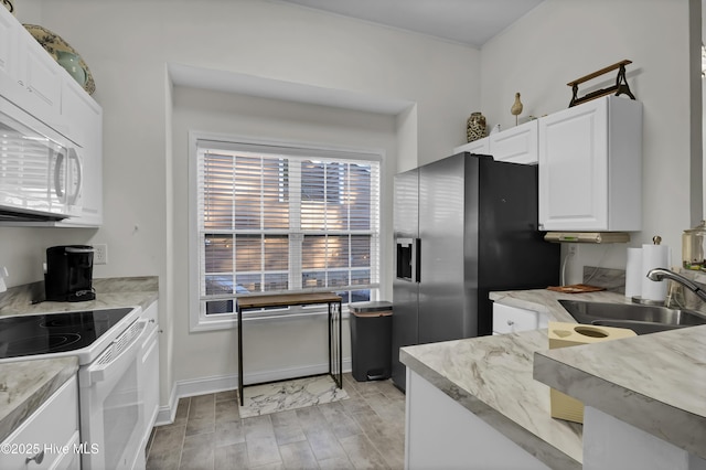 kitchen with white cabinets, white appliances, and sink