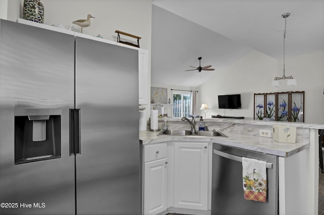 kitchen featuring white cabinetry, sink, ceiling fan, stainless steel appliances, and vaulted ceiling