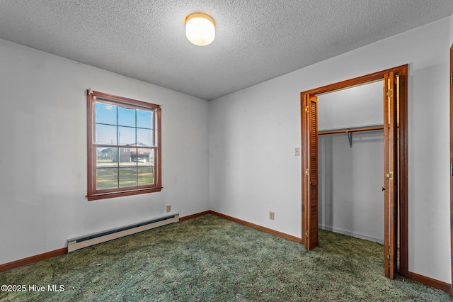 unfurnished bedroom with dark colored carpet, a textured ceiling, a closet, and baseboard heating