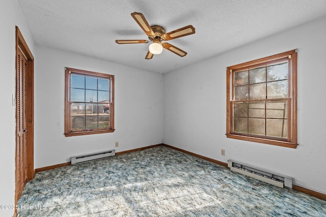 unfurnished room with carpet, a textured ceiling, and a baseboard radiator