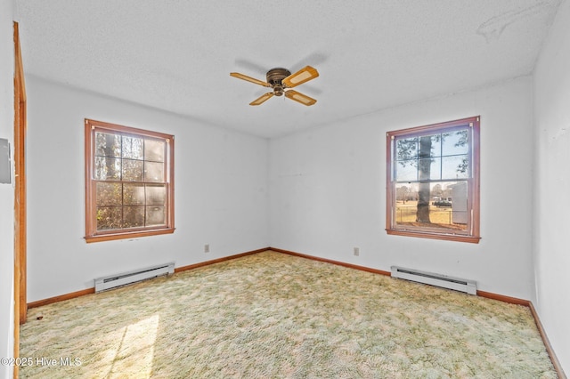 carpeted spare room with ceiling fan, a baseboard radiator, and a textured ceiling