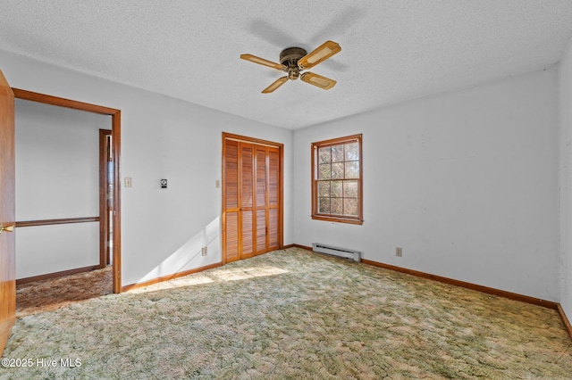 unfurnished bedroom featuring carpet flooring, ceiling fan, a textured ceiling, a baseboard radiator, and a closet