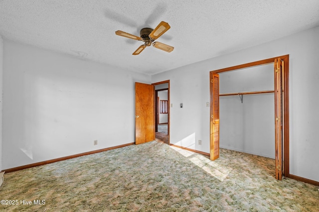 unfurnished bedroom with ceiling fan, light colored carpet, a textured ceiling, and a closet