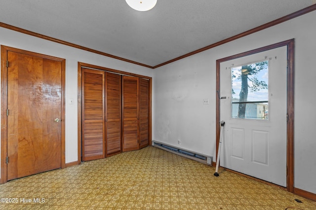 interior space with ornamental molding, a textured ceiling, and a baseboard heating unit