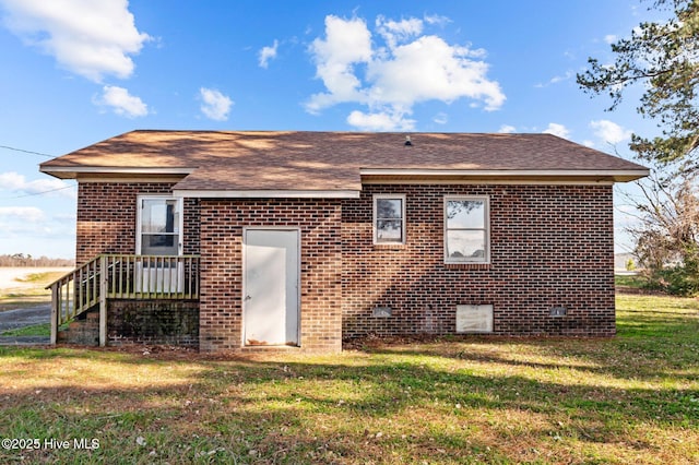 rear view of house with a lawn