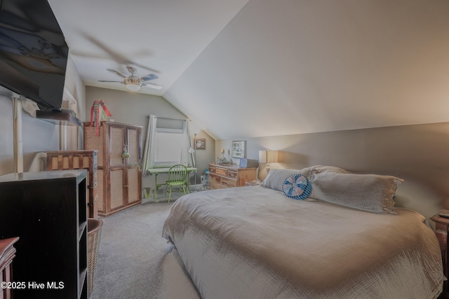 carpeted bedroom with vaulted ceiling and ceiling fan