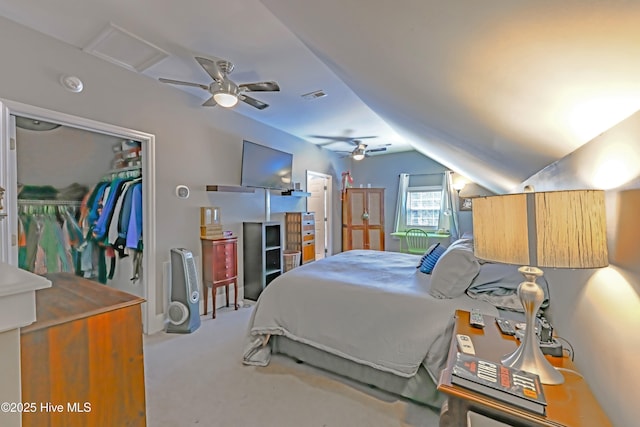 carpeted bedroom with vaulted ceiling, a closet, and ceiling fan