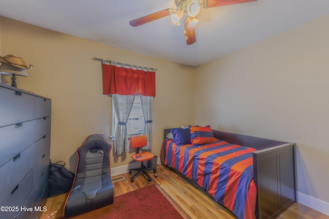 bedroom featuring ceiling fan and hardwood / wood-style flooring