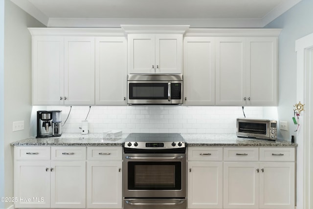 kitchen with appliances with stainless steel finishes and white cabinetry