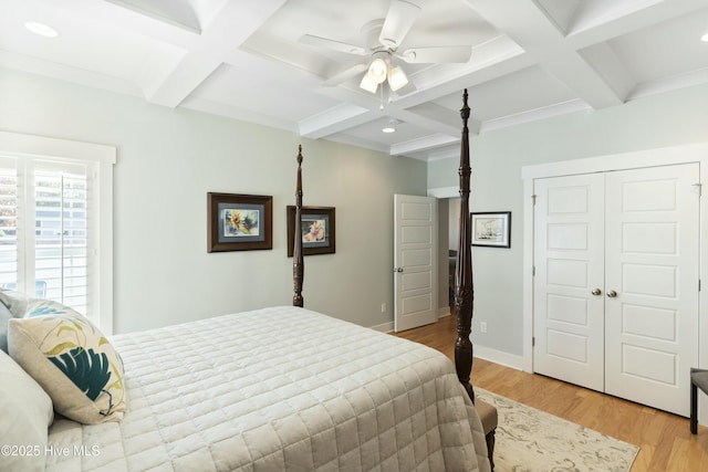 bedroom with beam ceiling, ceiling fan, light hardwood / wood-style flooring, and coffered ceiling