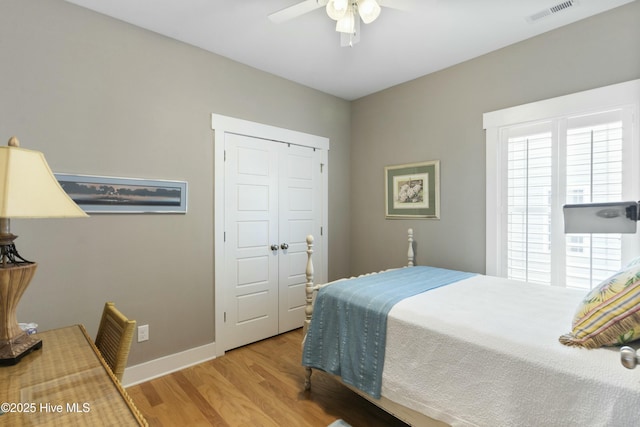 bedroom featuring light wood-type flooring, a closet, and ceiling fan