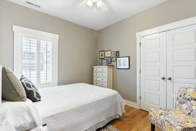 bedroom featuring wood-type flooring, a closet, and ceiling fan