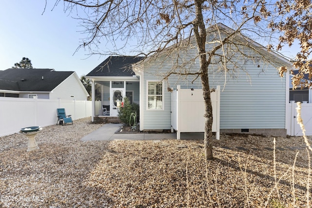 rear view of property with a sunroom