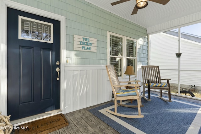 entrance to property with ceiling fan and covered porch