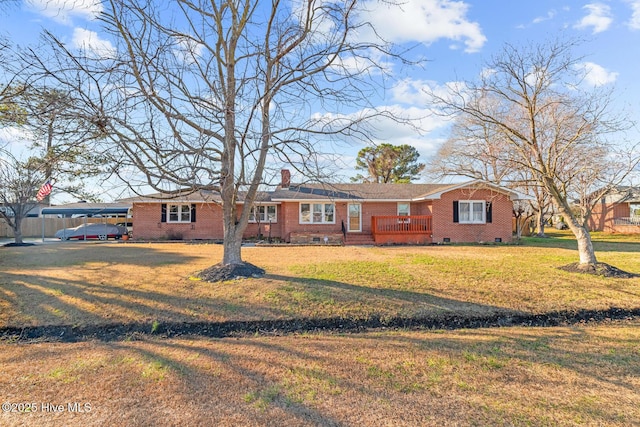 single story home with a front yard and a carport