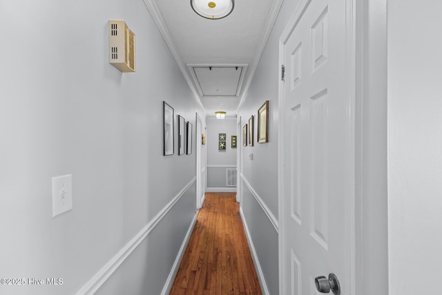 corridor with wood-type flooring and ornamental molding