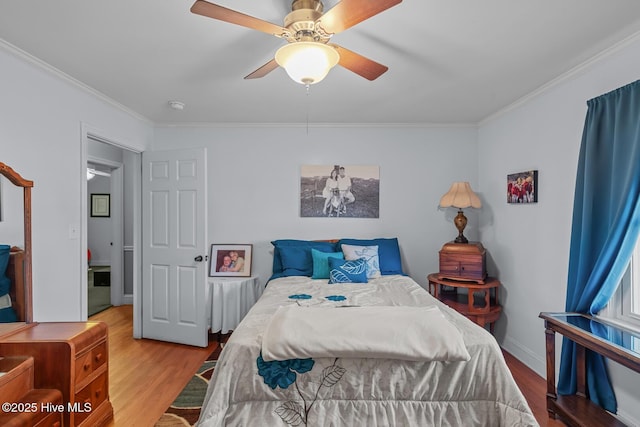 bedroom with ceiling fan, crown molding, and hardwood / wood-style flooring