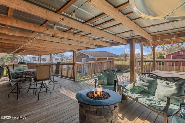 wooden deck with an outdoor living space with a fire pit