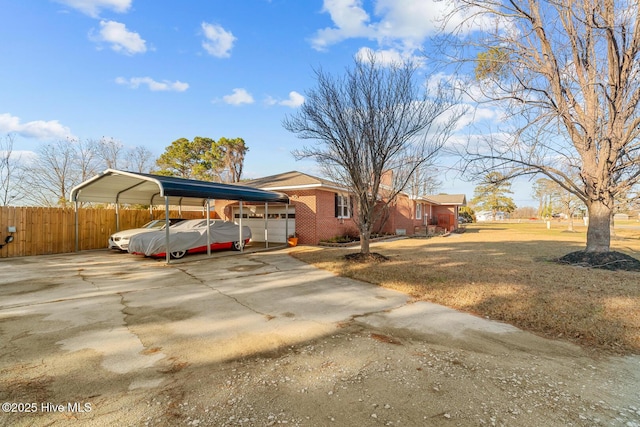 view of front facade with a carport and a front lawn