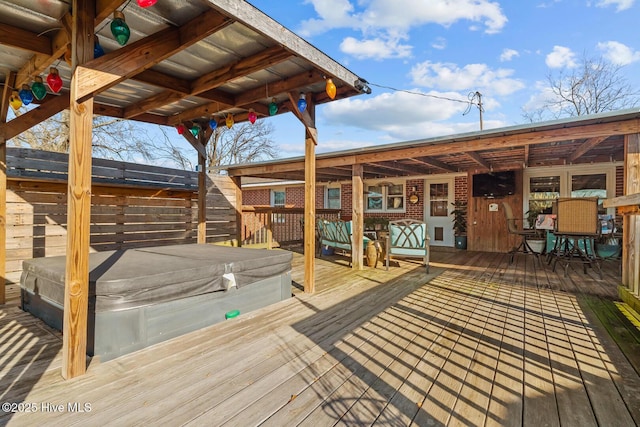 wooden deck with a hot tub