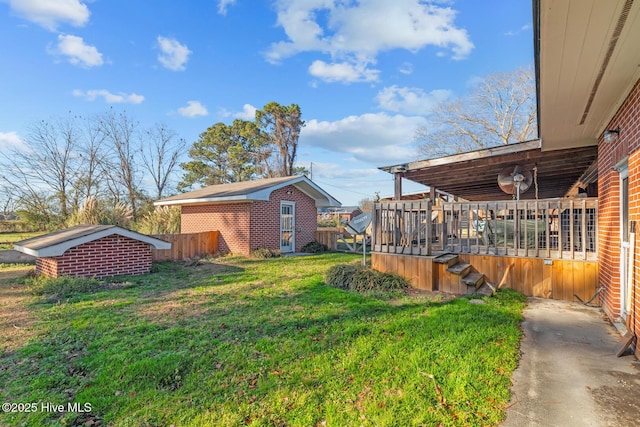 view of yard with an outbuilding and a deck