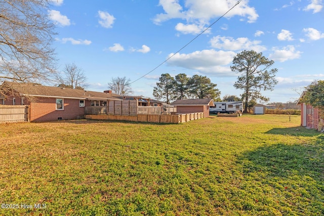 view of yard with a shed and a wooden deck