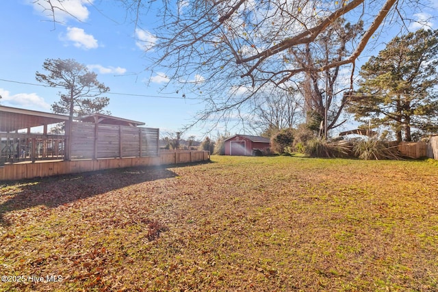 view of yard with an outdoor structure and a wooden deck