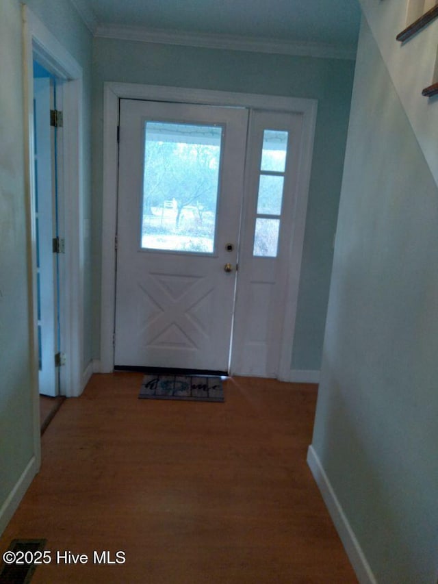 entryway with crown molding and hardwood / wood-style flooring