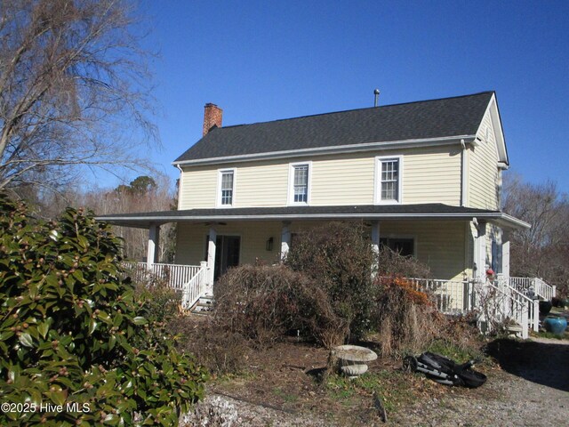 back of house with a wooden deck, central AC, and a lawn