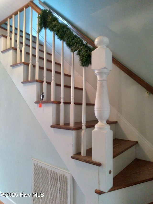 staircase featuring visible vents