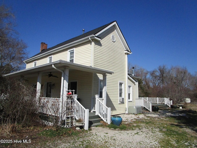 view of front of property featuring ceiling fan, central AC unit, and covered porch