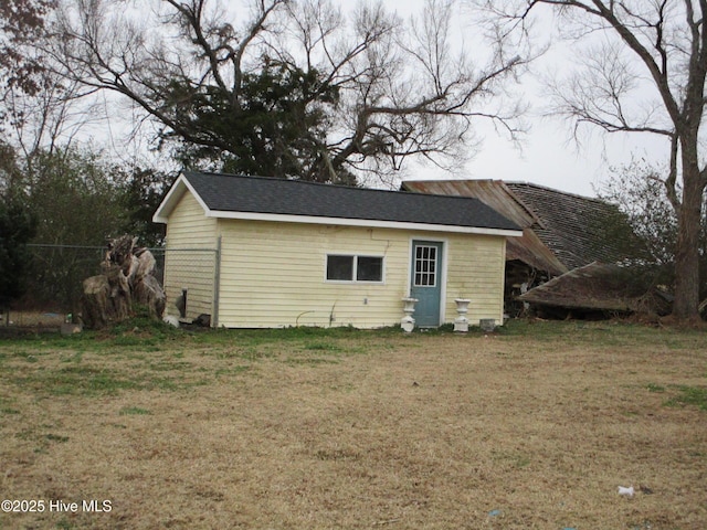 view of outbuilding featuring a lawn