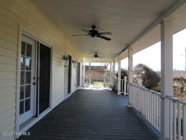 wooden terrace with a porch and ceiling fan