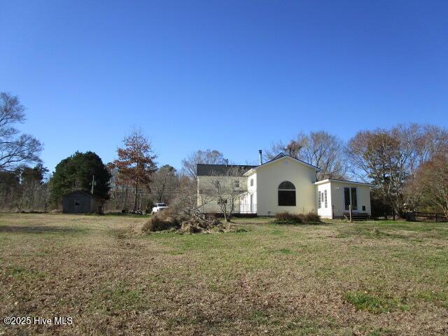 view of property exterior featuring a lawn