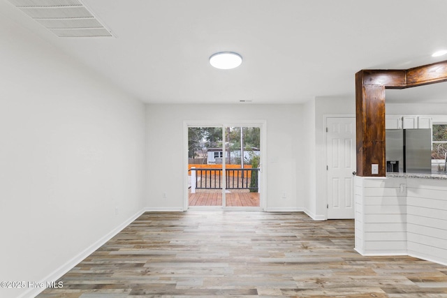 spare room with light hardwood / wood-style floors