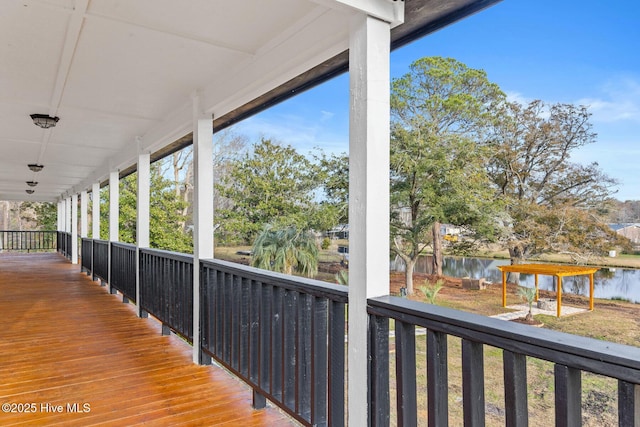 wooden terrace featuring a water view