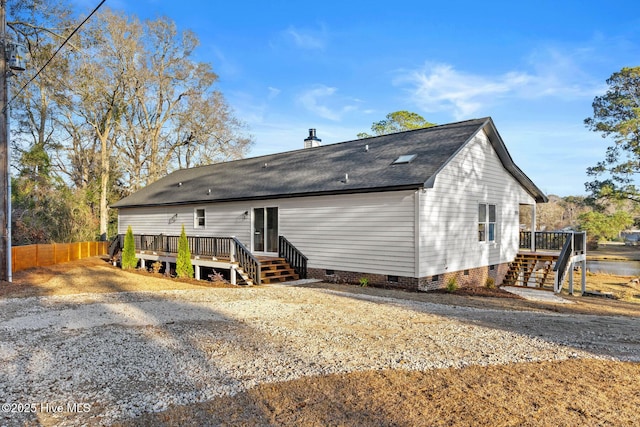 rear view of property featuring a deck