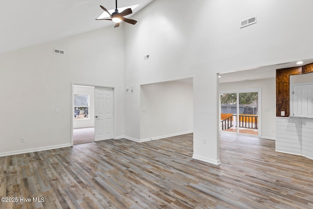 unfurnished living room with wood-type flooring, high vaulted ceiling, and ceiling fan