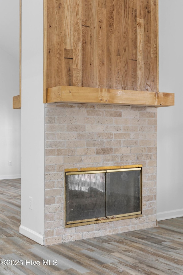 room details with a fireplace and hardwood / wood-style flooring