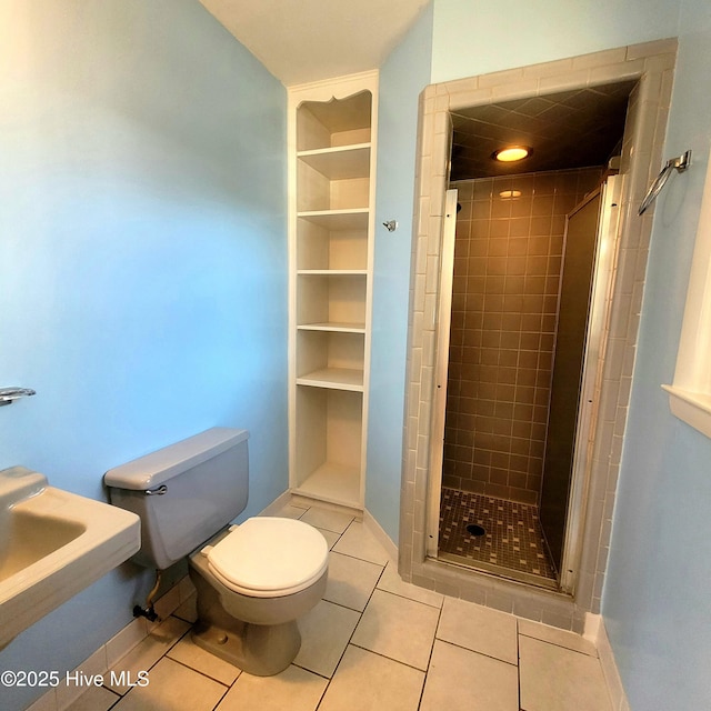 bathroom featuring an enclosed shower, tile patterned floors, and toilet