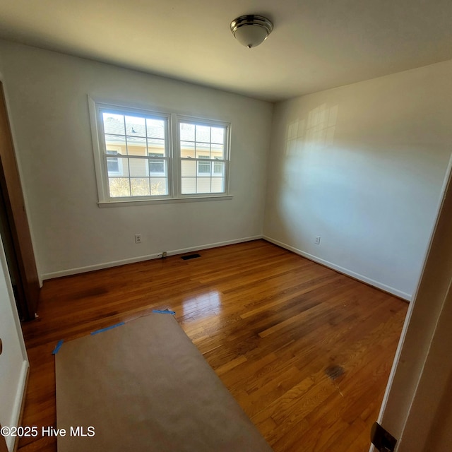 empty room featuring dark wood-type flooring