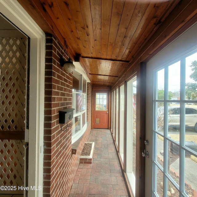 unfurnished sunroom with wooden ceiling