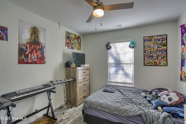 bedroom featuring ceiling fan and light hardwood / wood-style flooring